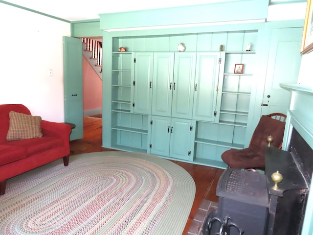 living area with dark wood-style floors and stairs