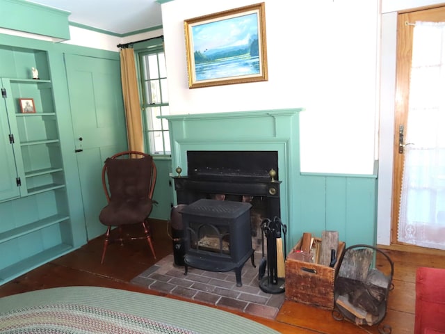 living area with a wealth of natural light and a wood stove