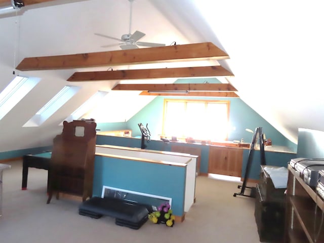 bonus room with lofted ceiling with skylight, carpet, and a ceiling fan