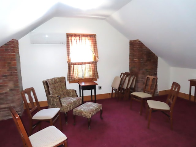 sitting room with lofted ceiling, baseboards, carpet floors, and an AC wall unit