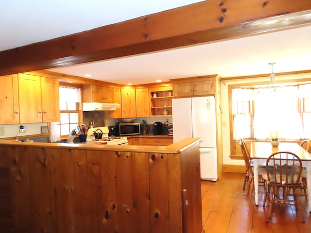 kitchen with white appliances, beamed ceiling, a peninsula, under cabinet range hood, and open shelves