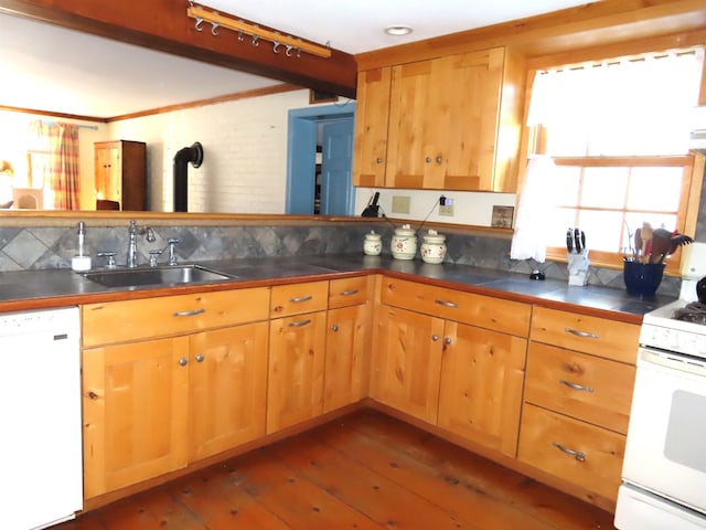 kitchen featuring white appliances, a sink, hardwood / wood-style floors, and decorative backsplash