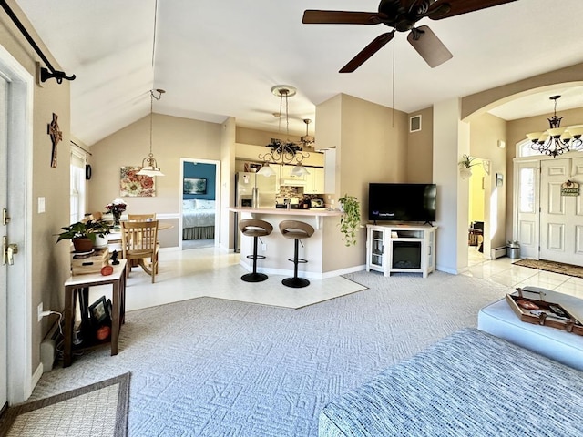 living area featuring arched walkways, light colored carpet, ceiling fan with notable chandelier, visible vents, and vaulted ceiling