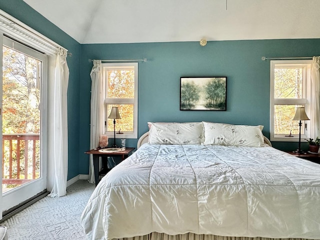 bedroom with lofted ceiling, carpet flooring, and baseboards