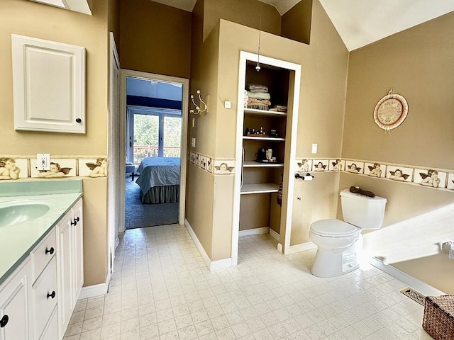 full bathroom featuring lofted ceiling, toilet, connected bathroom, vanity, and baseboards