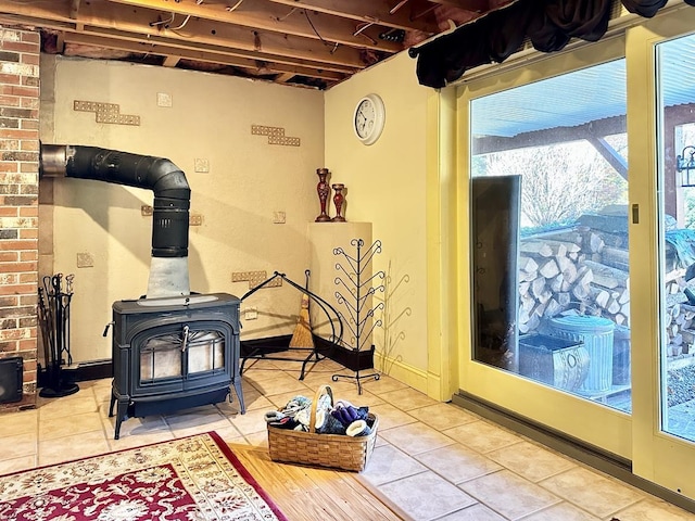 interior details with a wood stove and baseboards