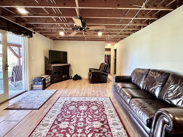 living area featuring a ceiling fan and wood finished floors