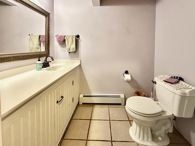 half bath featuring toilet, vanity, baseboard heating, and tile patterned floors