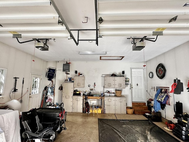 garage featuring a garage door opener and a workshop area