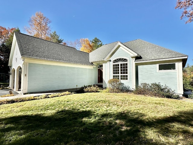 ranch-style house with a front yard and roof with shingles