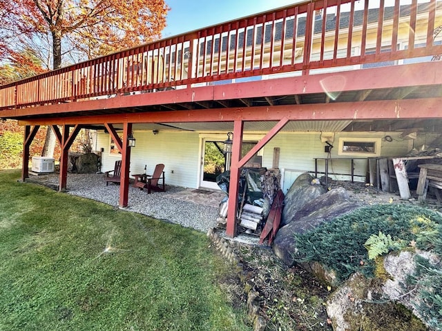 back of house featuring a lawn and central air condition unit