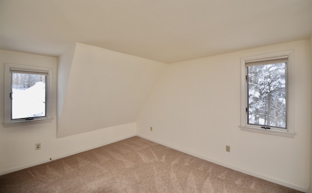 spare room with a healthy amount of sunlight and light colored carpet