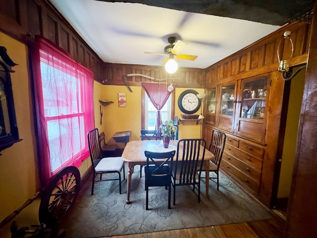 dining space with ceiling fan and wood finished floors