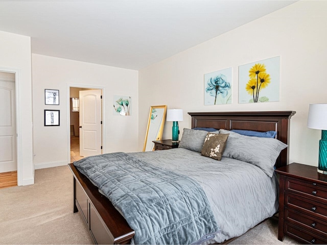 bedroom featuring baseboards and light colored carpet