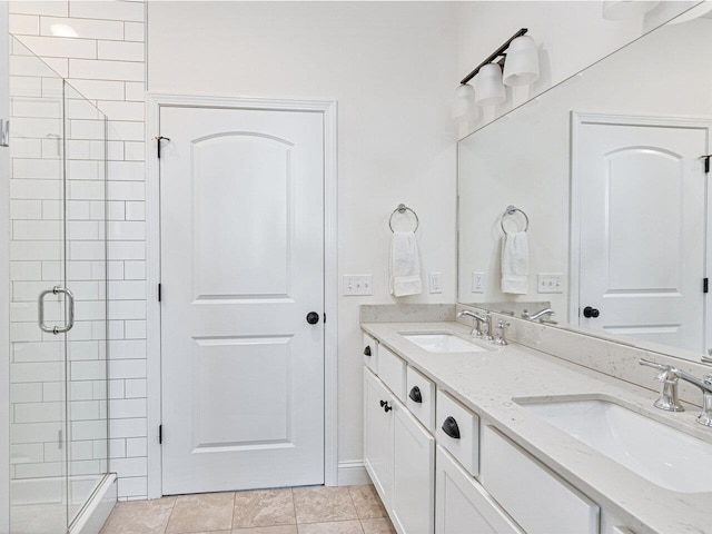 full bath featuring a stall shower, tile patterned flooring, and a sink