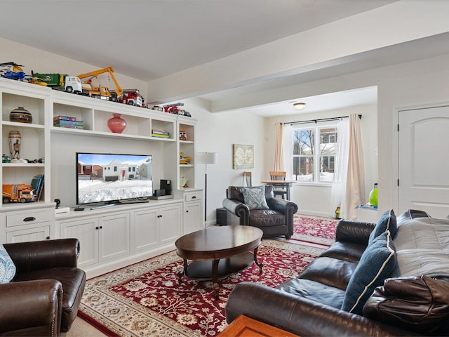 living area featuring beam ceiling