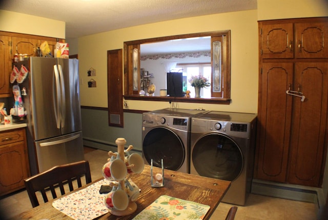 washroom with laundry area, washer and clothes dryer, and baseboard heating