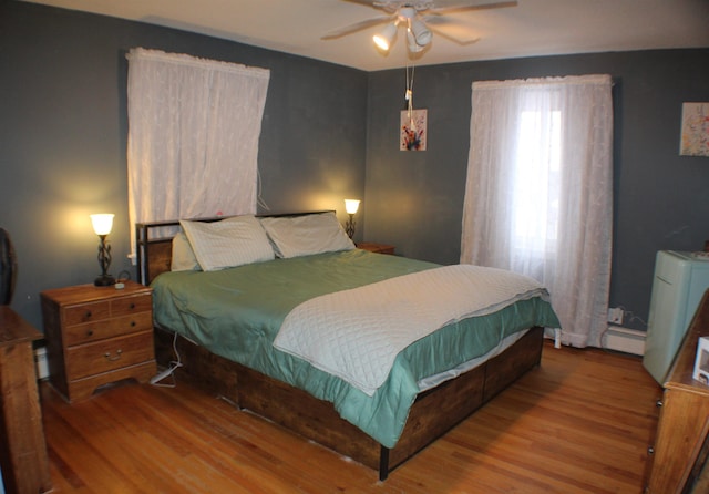 bedroom featuring wood finished floors and a ceiling fan