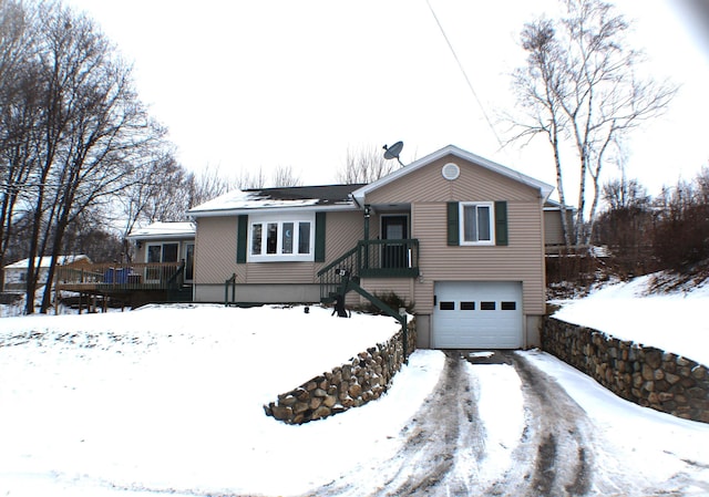 view of front of home featuring an attached garage and a deck