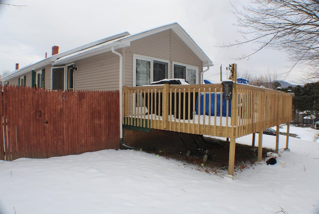 view of snowy exterior with a deck