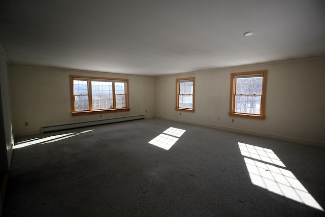 carpeted empty room featuring a baseboard heating unit, baseboards, and crown molding