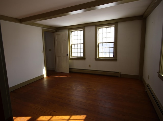 spare room featuring baseboards, baseboard heating, and hardwood / wood-style floors