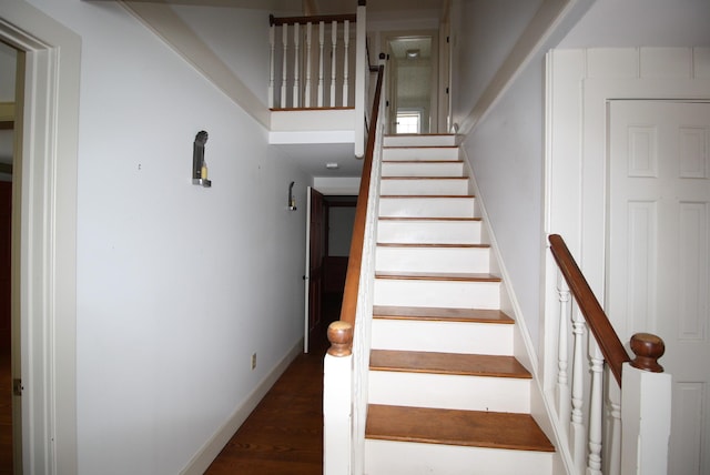 stairway with baseboards and wood finished floors