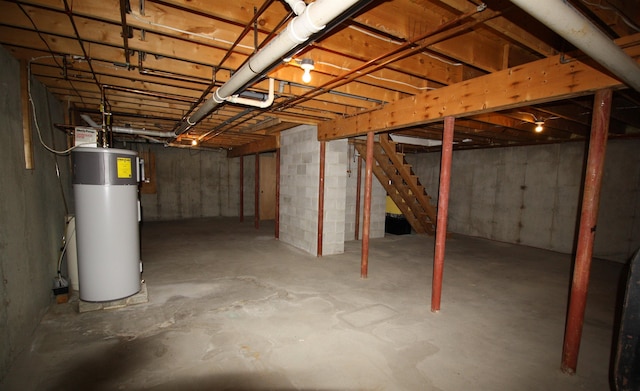 unfinished below grade area featuring water heater