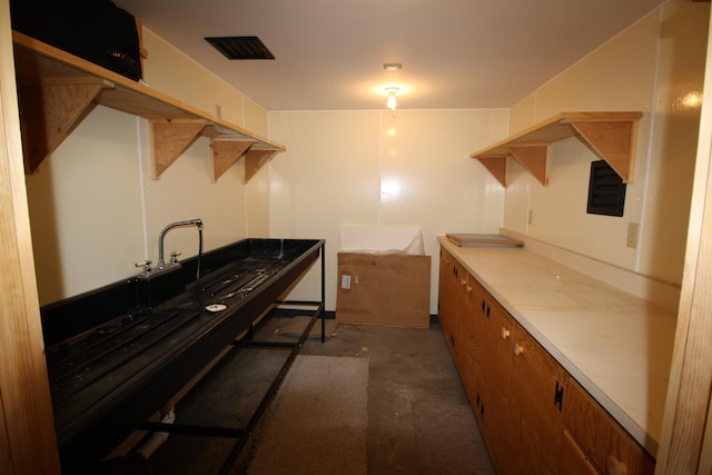 interior space with visible vents, brown cabinets, and concrete flooring