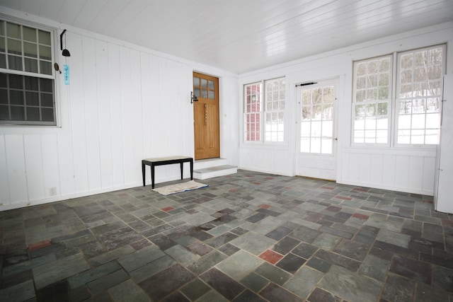 empty room with brick floor and wooden ceiling