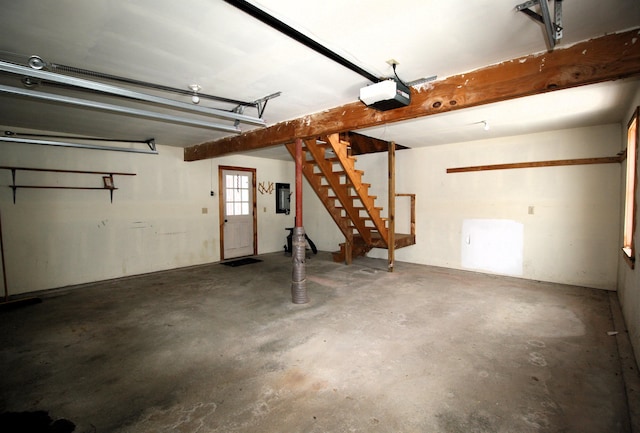 garage with electric panel and a garage door opener