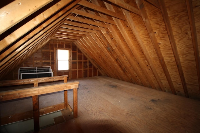 unfinished attic with an upstairs landing