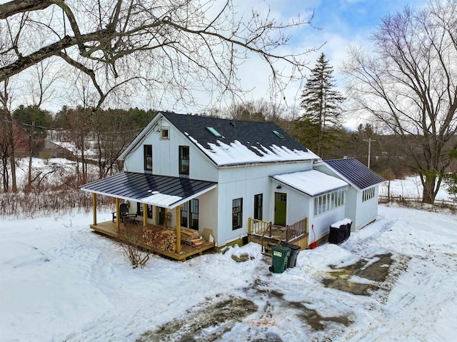 view of front of home featuring a standing seam roof, a deck, and metal roof