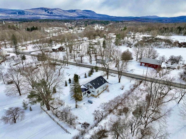 snowy aerial view featuring a mountain view