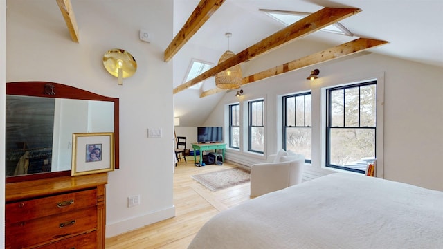 bedroom with light wood-style floors, lofted ceiling with beams, and baseboards