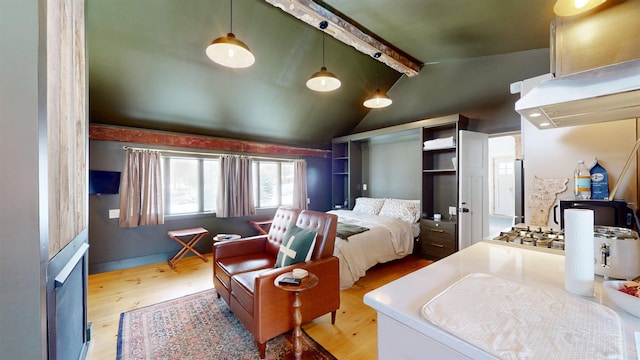 bedroom featuring lofted ceiling with beams and wood finished floors