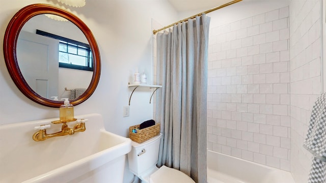 full bathroom featuring shower / bath combination with curtain, a sink, and toilet