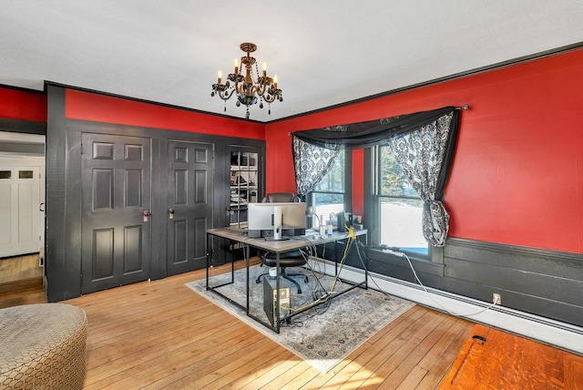 office featuring wainscoting, a baseboard radiator, wood-type flooring, and an inviting chandelier