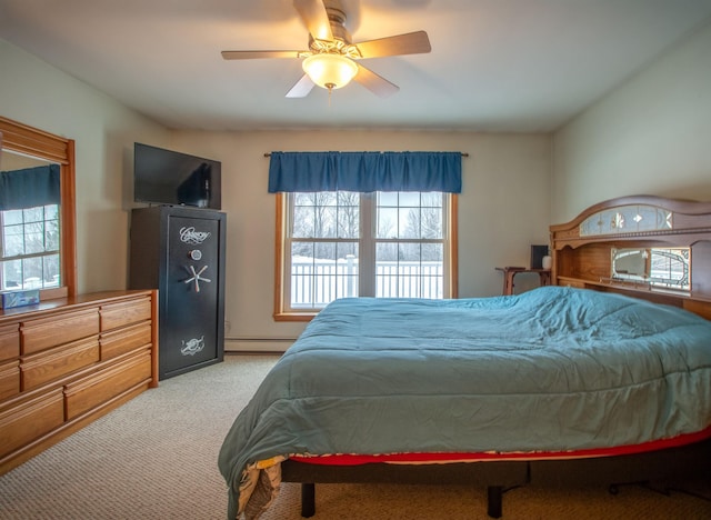 bedroom featuring carpet floors, baseboard heating, and a ceiling fan