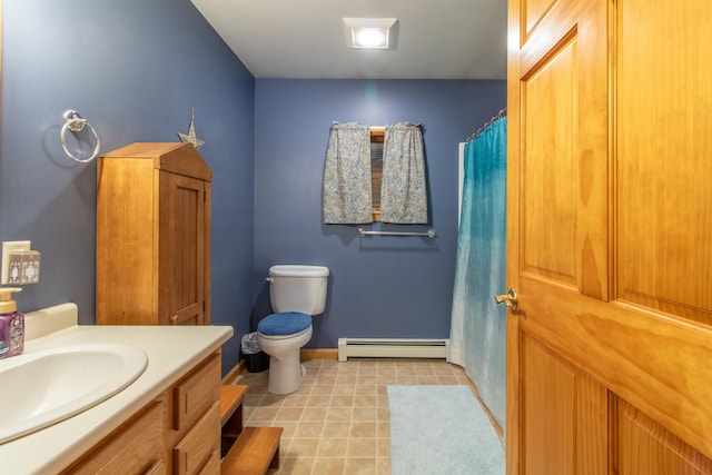 bathroom with toilet, a baseboard heating unit, vanity, tile patterned flooring, and baseboards