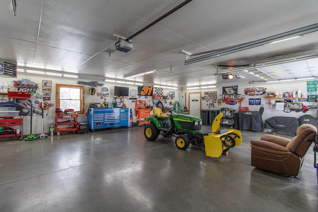 garage with a workshop area and a garage door opener