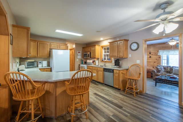 kitchen with stainless steel appliances, light countertops, and light wood finished floors