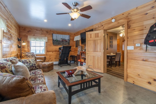 living room featuring wood walls, a ceiling fan, and recessed lighting