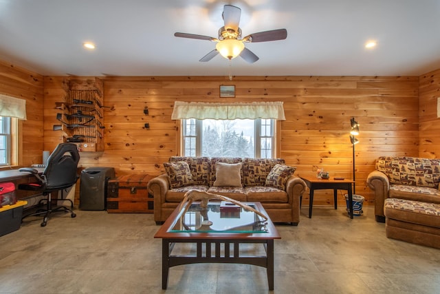 living area featuring a ceiling fan, recessed lighting, and wooden walls