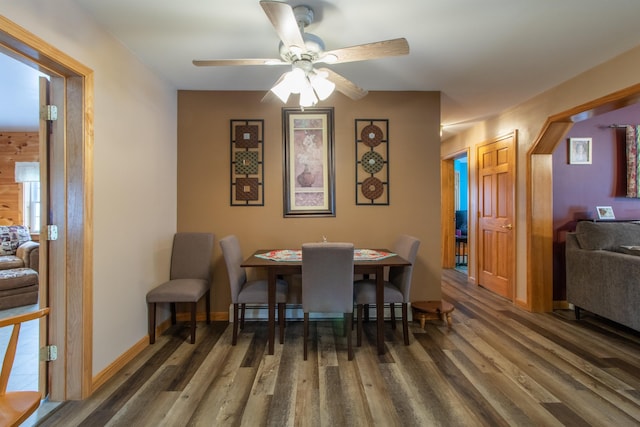 dining room featuring ceiling fan, baseboards, and wood finished floors