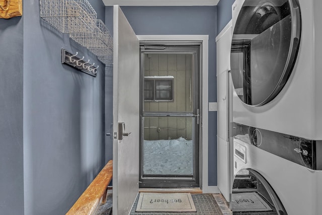 washroom with laundry area and stacked washer / drying machine