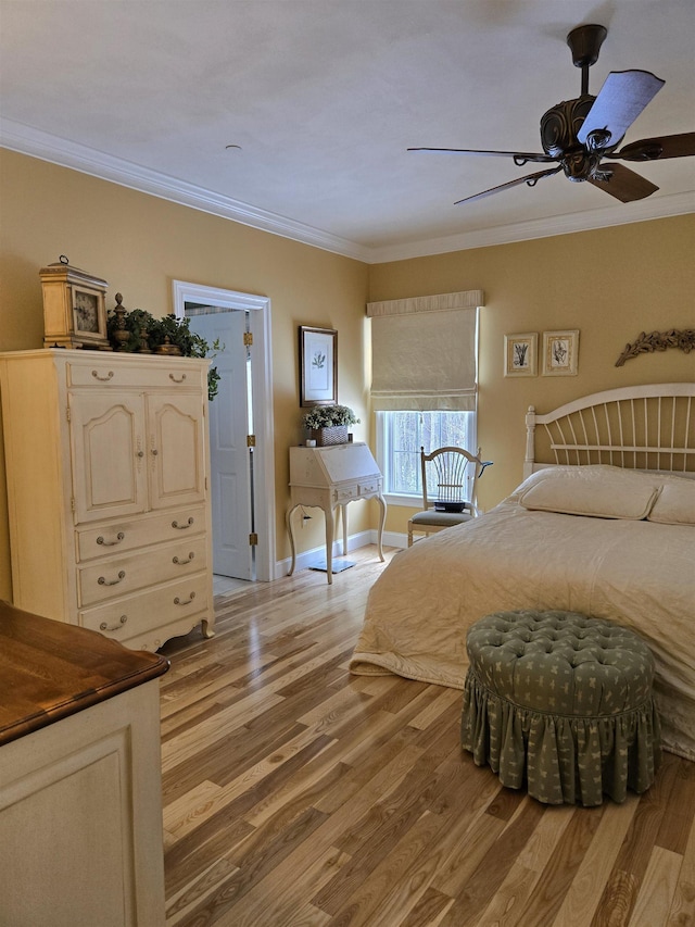 bedroom with ornamental molding, light wood-type flooring, a ceiling fan, and baseboards