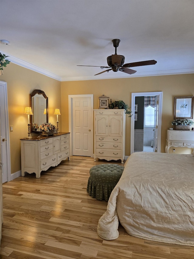 bedroom with ensuite bathroom, ornamental molding, ceiling fan, light wood-type flooring, and baseboards