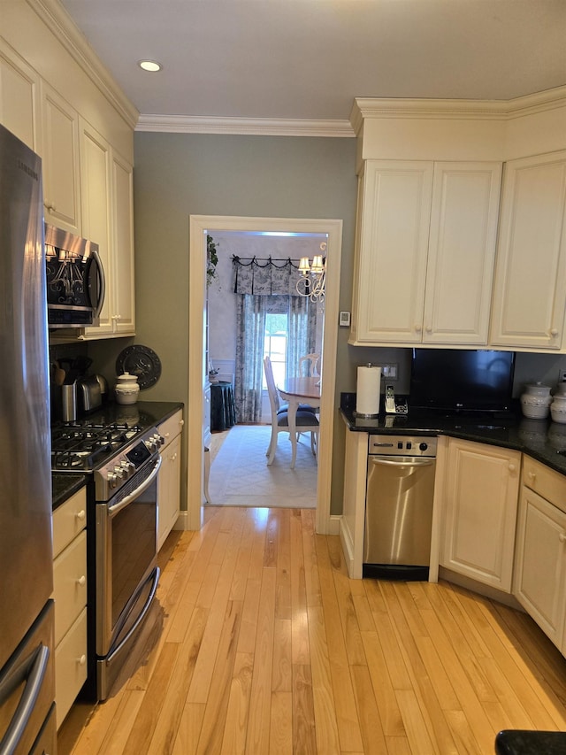 kitchen featuring stainless steel appliances, dark countertops, and crown molding