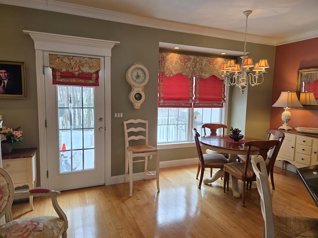 dining area with a wealth of natural light, light wood-type flooring, a chandelier, and crown molding